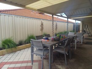 outdoor table and chairs under a patio