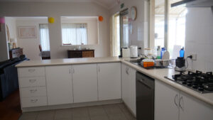 kitchen area with cabinetry and benchtops